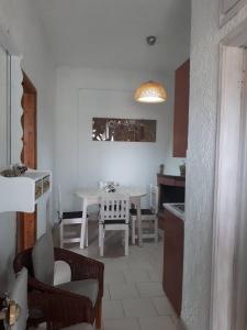 a kitchen and living room with a table and chairs at Εmmi in Koutsounari +33 photos