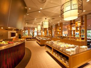a restaurant with several tables with food on display at Hotel Nikko Narita in Narita
