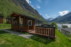 a cabin with a view of a mountain at Grande Hytteutleige og Camping in Geiranger