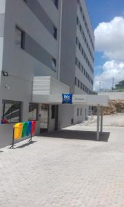 a building with a rainbow bench in front of it at ibis budget Divinopolis in Divinópolis