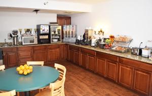 a kitchen with a table and a counter top at Beachfront Hotel Houghton Lake in Houghton Lake