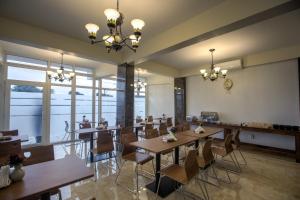 a dining room with wooden tables and chairs at Royal Mansion in Paramaribo