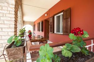 a balcony with a table and chairs and plants at Apartments Aria in Zadar