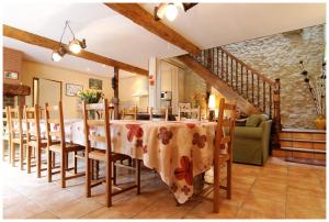 a kitchen and dining room with a table and chairs at La Ferme des Grisettes in Montesquiou