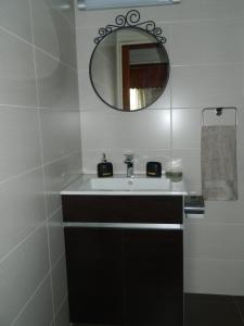 a bathroom with a sink and a mirror at Family Nest In The Heart Of Limassol in Limassol