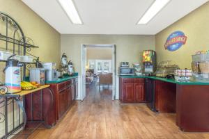 a kitchen with wooden cabinets and green counter tops at Baymont by Wyndham Easley/Greenville in Easley