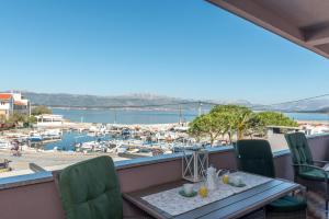 a balcony with a table and chairs and a marina at Villa Domic in Slatine