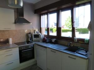 a kitchen with a sink and a counter top at la maison de Lucie in Surbourg