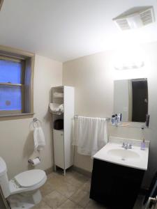 a bathroom with a white toilet and a sink at Mt Vernon Flat - Ground Level Furnished Apartment Near Downtown in Baltimore