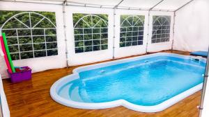 a large hot tub in a tent with windows at Apartamenty Pan Tadeusz Ustroń in Ustroń