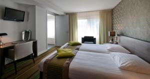 Postel nebo postele na pokoji v ubytování Parkhotel Valkenburg