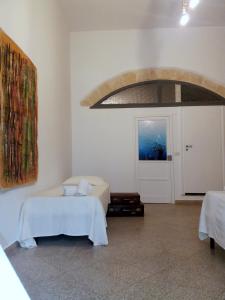シラクーサにあるLa casa di Adeleの白い部屋(ベッド1台、ドア付)