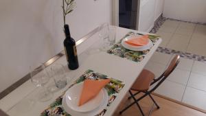 einen weißen Tisch mit einer Flasche Wein und Gläsern in der Unterkunft Estudio Los Molinos in La Laguna