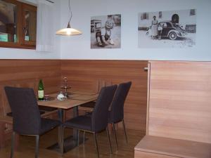 a dining room with a table and chairs and a car at St. Ulrichhof in Lana