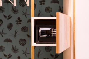 a pay phone sitting inside of a cabinet at Horti 14 Borgo Trastevere Hotel in Rome