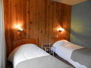 En eller flere senge i et værelse på Hotel La Gare