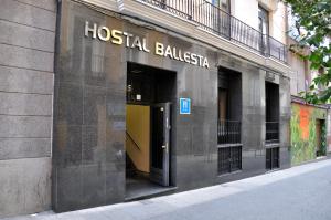 a building with a sign on the side of it at Hostal Ballesta in Madrid