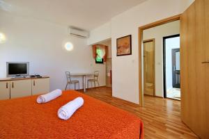 a bedroom with a bed with two white pillows on it at Sun Palace Residence in Premantura