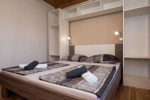 a bed with two pillows on it in a room at Apartment Antonio in Vir