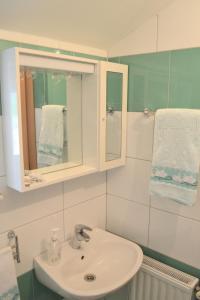 a bathroom with a sink and a mirror at Apartments Dragun in Podstrana +20 photos