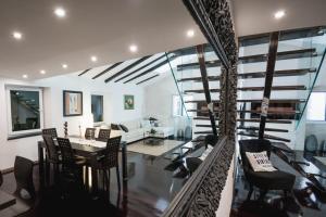 a dining room and living room with a spiral staircase at Apartment Magic Dream in Šibenik