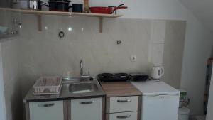 a small kitchen with a sink and a stove at Anka's Beach in Komiža