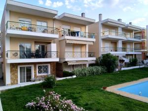an apartment building with a yard and a swimming pool at Vereniki 2 in Kriopigi