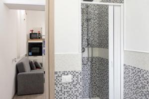 a bathroom with a shower with a chair in it at San Vito Lo Capo da Ciccio in San Vito lo Capo +99 photos