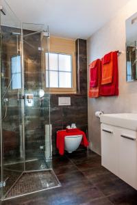 a bathroom with a shower and a sink and a tub at Holiday flat #1, Chalet Aberot, Wengen, Switzerland in Wengen