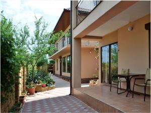 an internal courtyard of a house with a table and chairs at Morskyi 487 in Zatoka
