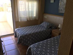Postel nebo postele na pokoji v ubytování Apartamentos SOL y PLAYA Torremolinos