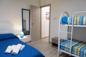 a bedroom with a bunk bed and a mirror at San Vito Lo Capo da Ciccio in San Vito lo Capo