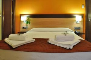 Кровать или кровати в номере Hostal Ballesta