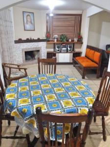 a living room with a table with a blue and yellow quilt at Recanto do Sossego in Campos do Jordão