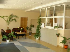 a living room filled with lots of potted plants at Abilana in Palanga