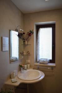 a bathroom with a sink and a window at Casa delle Rondini in Alberobello