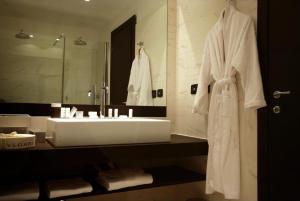 a bathroom with a white sink and a mirror at Hotel Indigo Turin, an IHG Hotel in Turin