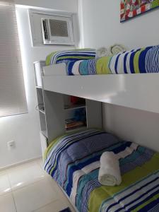 a bedroom with two bunk beds with towels on them at Apartamento em Cabo Frio in Cabo Frio