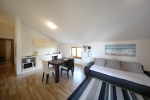 a living room with a couch and a table and a kitchen at Apartment Mareta in Zadar