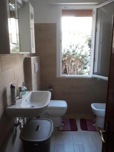 a bathroom with a sink and a toilet and a window at Venice Concordia Guesthouse in Marghera +52 photos