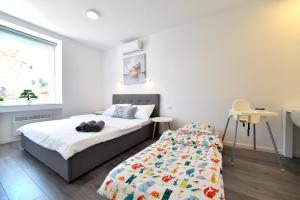 Posteľ alebo postele v izbe v ubytovaní At queens