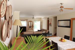 a living room with a table and a couch at Casa Lua Guesthouse in Burgau