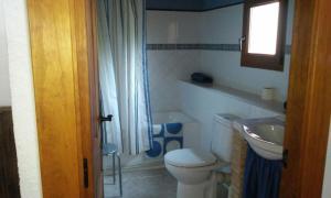 a bathroom with a toilet and a sink at Casa La Abuela in San Mamés