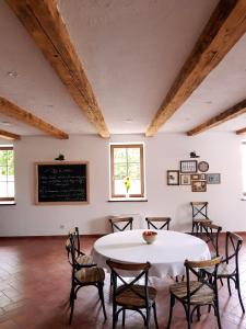a room with a table and chairs and a chalkboard at BASALTINA Panzió in Balatonederics
