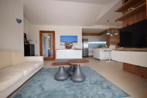 a living room with a couch and a table at VILLA BAIRES - CHIA in Domus de Maria