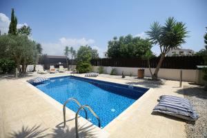 a swimming pool in the middle of a yard at Unique Beach Luxurious Villas in Ayia Napa +24 photos
