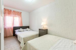 Postel nebo postele na pokoji v ubytování Apartments Karlo