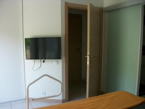 a bedroom with a flat screen tv on a wall at villa terrefort in Drémil-Lafage