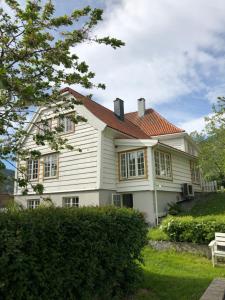 a white house with a red roof at Stryn - house by the river in Stryn