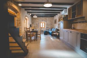 a kitchen and living room with a table and chairs at Holiday Home Jela in Dobrinj